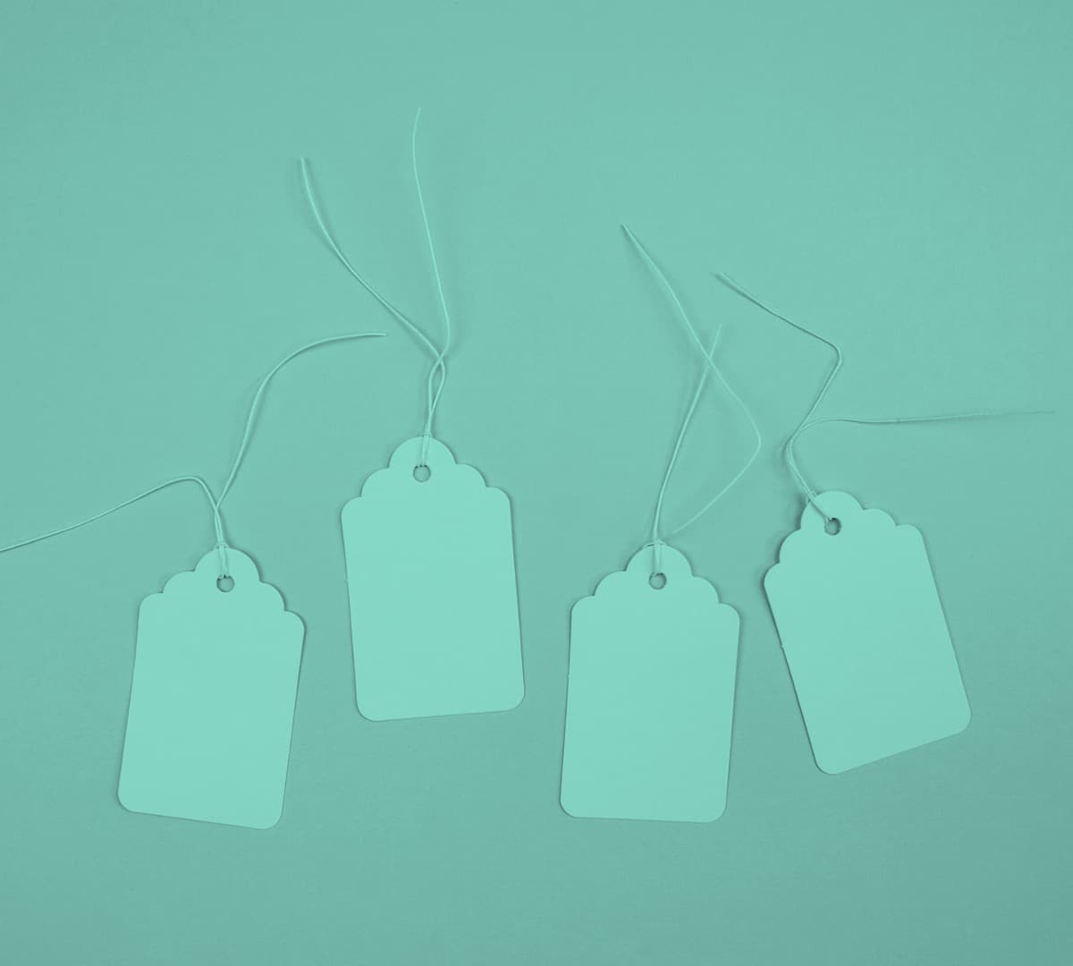 Four blank shopping tags with a green overlay on the entire image.