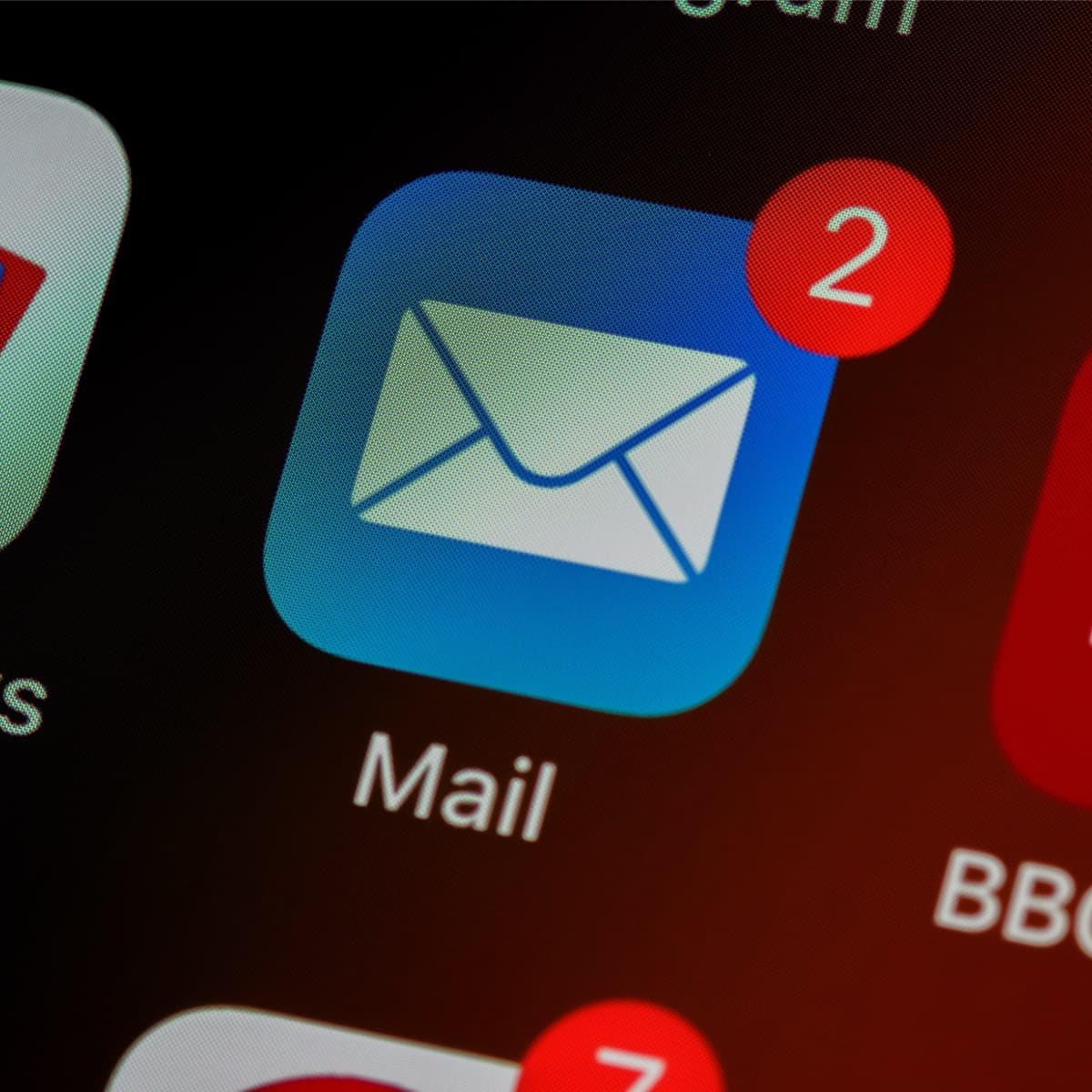 Image of a phone screen with the Mail app in the center. App has 2 notifications indicated by a red circle with "2" in it.