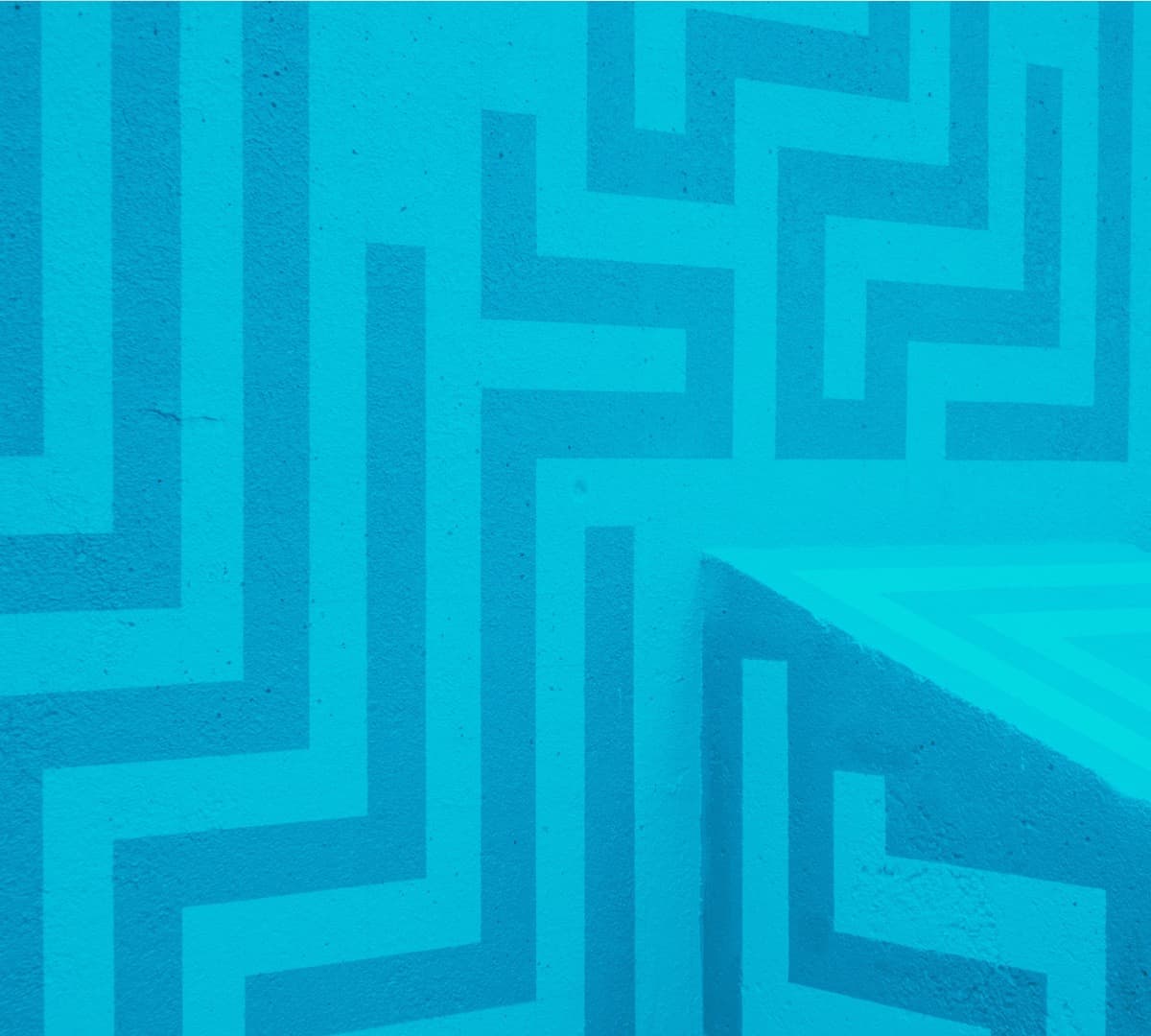 Light and dark blue lines forming a pattern on a wall.